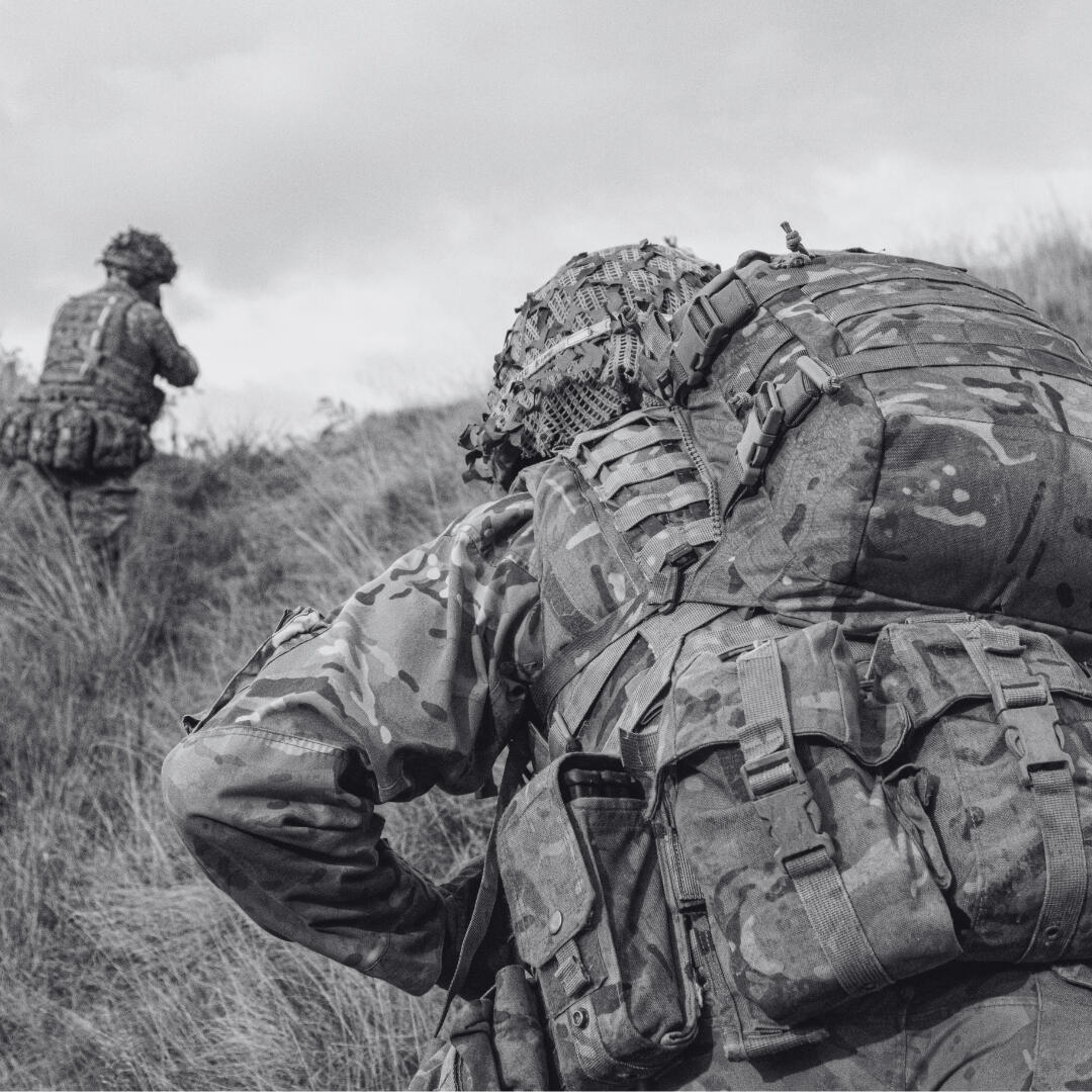 two soldiers moving across ground